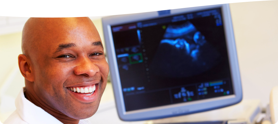 doctor smiling because of the output of the ultrasound